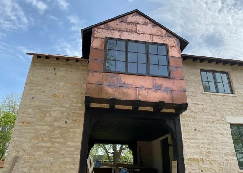 Copper metal panel facade on a stone building for Skylight Installation in Whitewater